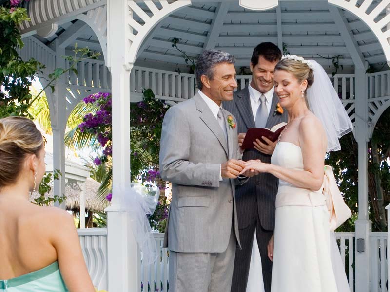 couple standing at wedding venue vows bright smiles
