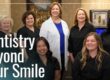 Doctor and staff smiling for group photo