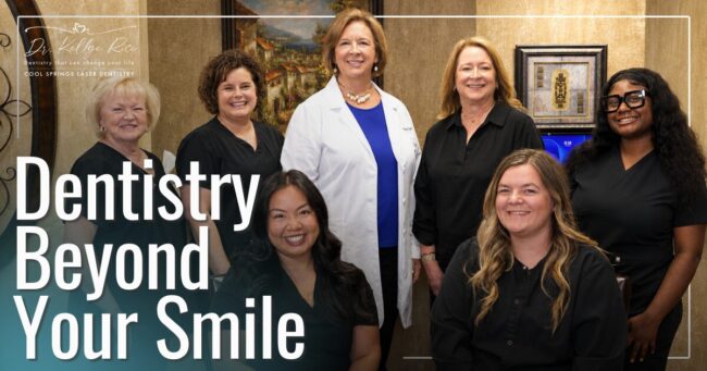 Doctor and staff smiling for group photo