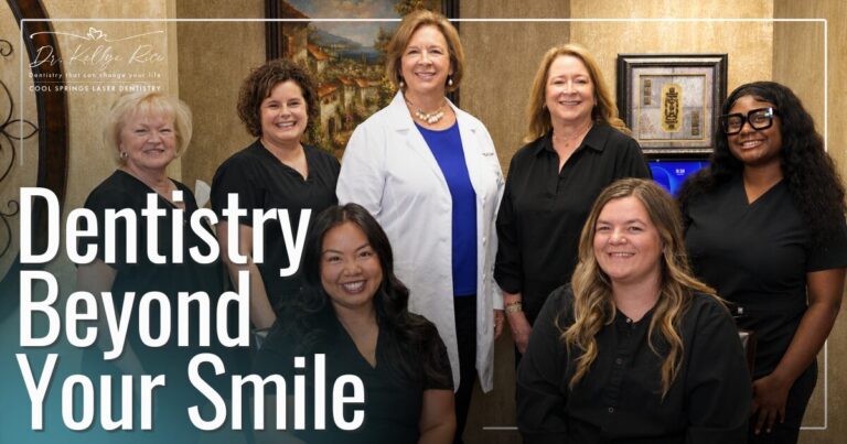 Doctor and staff smiling for group photo